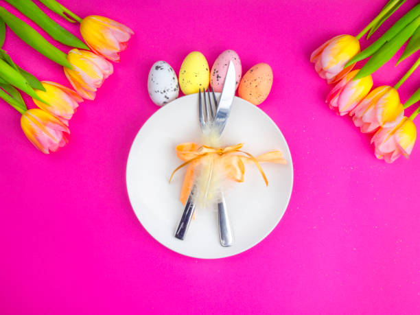 istock easter cutlery with knife, fork, eggs, flowers on pink background 1209873618