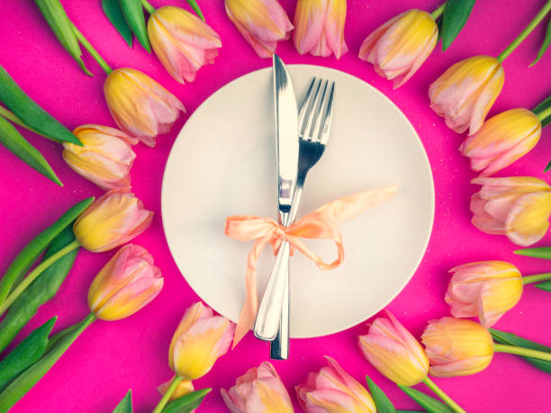 istock composition for Easter with tulip and plate with cutlery 1209873743