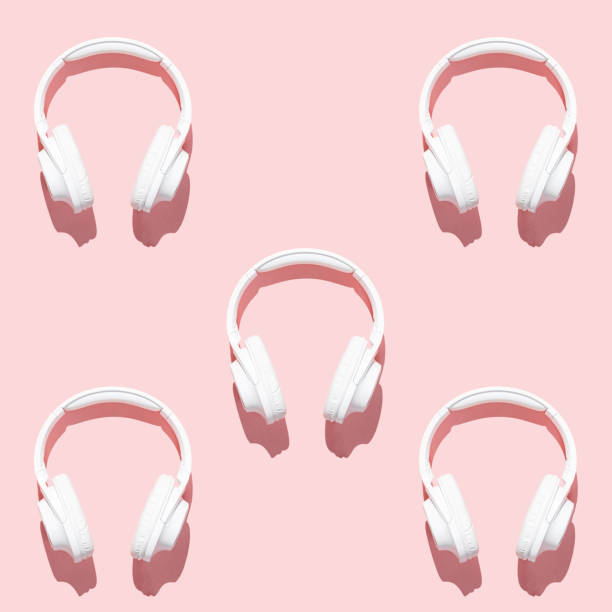 istock Pattern white headphones on modern pale pink table top view flat lay. Free space for creative design text and content 1209874256