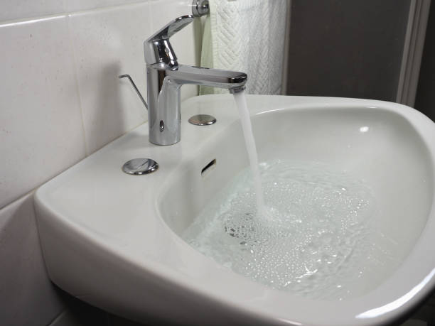 istock tap faucet in basin 1209875167