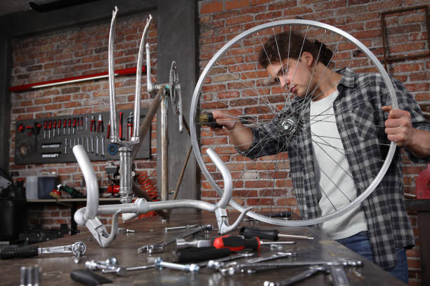 istock man repair the bicycle in garage workshop on the workbench with tools, with the brush on the wheel, diy concept, red bricks background 1209875782