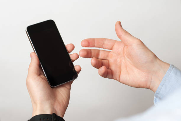 istock Hand holding and Touch on Black Smartphone with blank screen on white background 1209875796