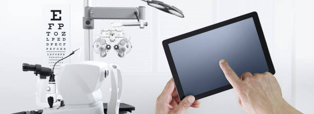istock eye examination test concept, hands touch screen of digital tablet, ophthalmology and optometry equipment on background 1209877087