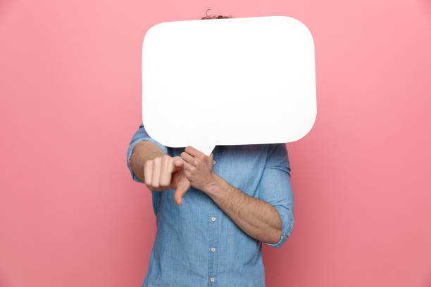 istock young casual man hiding behind speech bubble 1209877204
