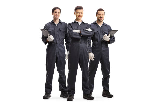 trois ouvriers de mécanique dans des uniformes - manual worker full length isolated on white standing photos et images de collection