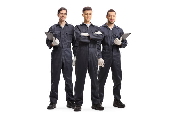 Three mechanic workers in uniforms Full length portrait of three mechanic workers in uniforms isolated on white background repairman stock pictures, royalty-free photos & images