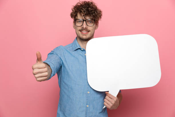 istock casual happy guy holding speech bubble and smiling 1209878509