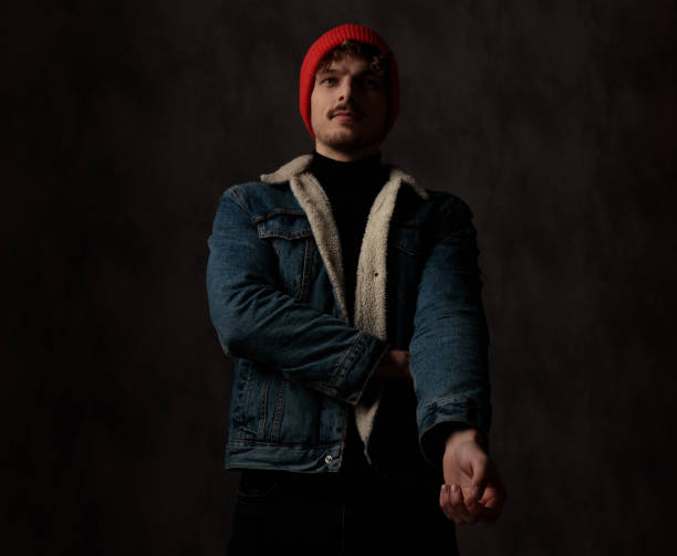 istock dramatic cool model holding arm in a fashion pose 1209879725