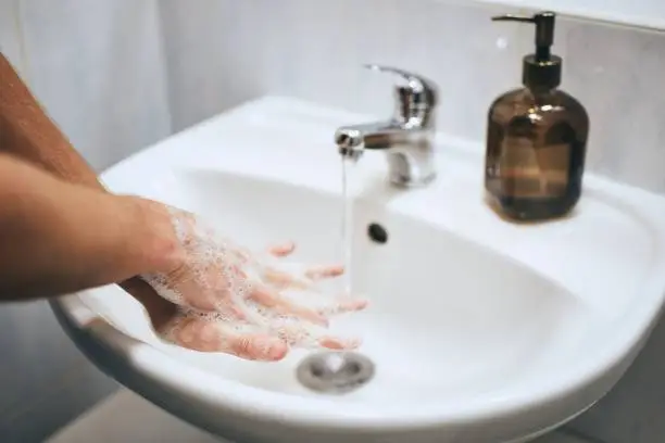 Washing hands at home in bathroom. Healthy lifestyle, hygiene and prevention viral and bacterial diseases.