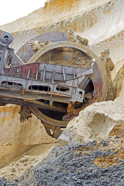 istock Bucket-wheel excavator during excavation at the surface mine. Huge excavator on open pit mine. 1209879861