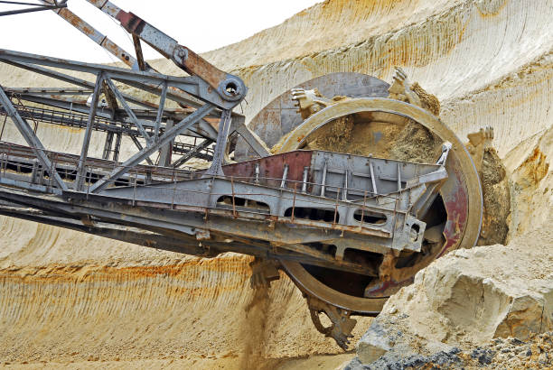 istock Bucket-wheel excavator during excavation at the surface mine. Huge excavator on open pit mine. 1209879864