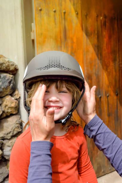 istock little girl preparing to ride her pony 1209879939