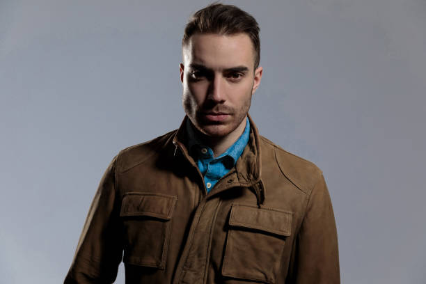 istock Confident fashion model looking forward while wearing leather jacket 1209881922
