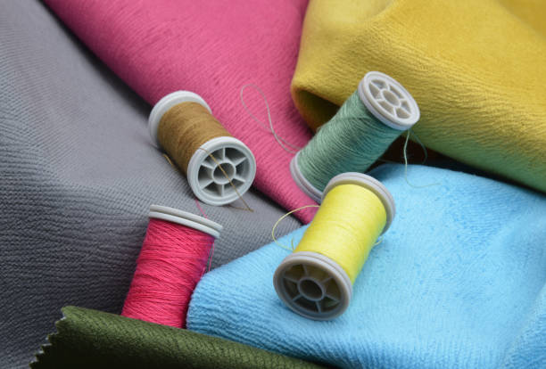 istock colorful spools of thread on fabric background 1209882198