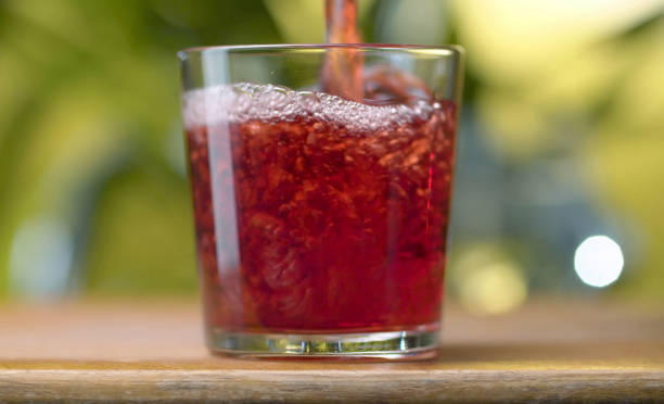 istock Red juice pouring into the glass 1209882257