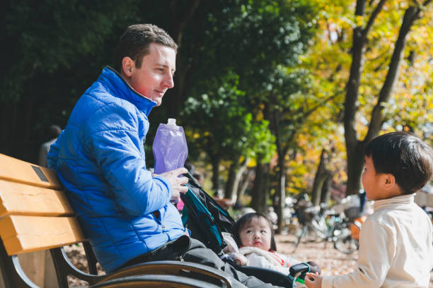istock father and kids having a lunch in the park 1209884340