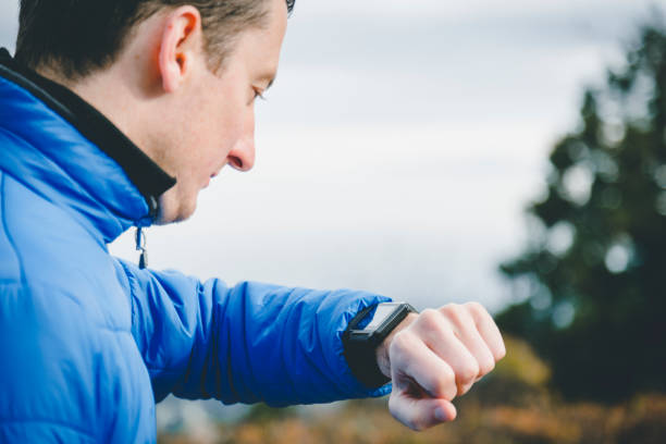 istock Man using a smart watch while hiking in the mountain 1209884398