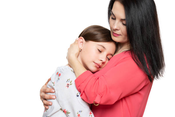 Worried mother embracing and consoling her young daughter. Family relationships concept. Worried mother embracing and consoling her young daughter. Family relationships concept. forgiveness photos stock pictures, royalty-free photos & images