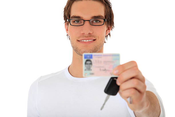 istock Young man shows driver license and car keys 120988506