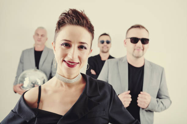 istock Smiling female singer and her band 1209885673