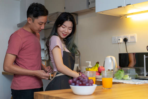 istock Couple putting in aprons before cooking 1209886196