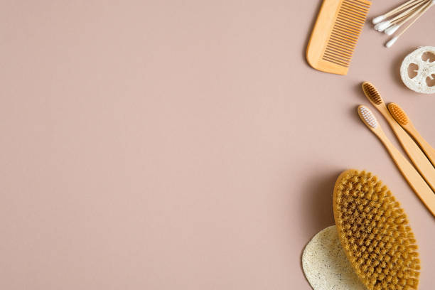 istock Eco-friendly bath accessories on brown background. Flat lay cotton ear sticks, bamboo toothbrushes, hair comb, bath peeling brush, luffa sponge. Beauty and SPA treatment concept 1209886524
