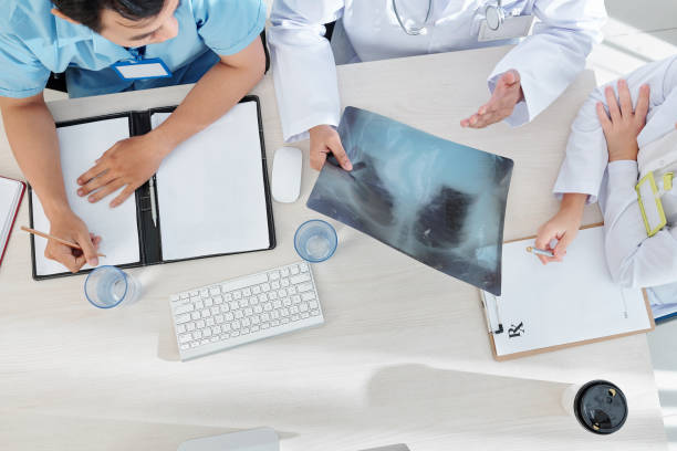 istock Doctors discussing x-ray of patient 1209887839