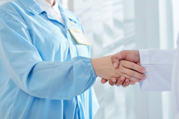 istock Surgeon shaking hand of physician 1209887892