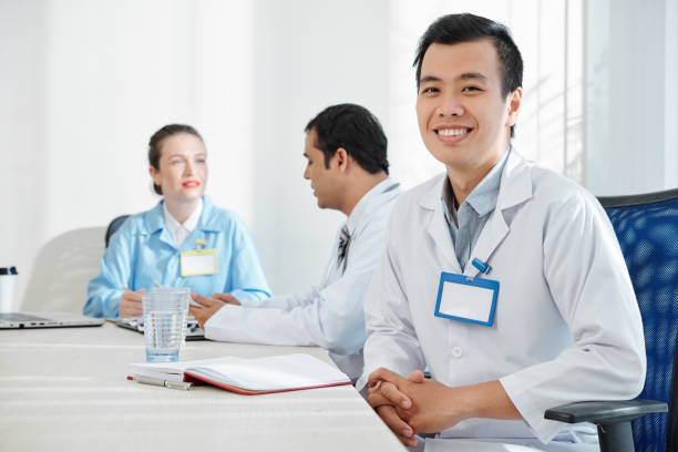 istock Intern attending meeting in hospital 1209887982