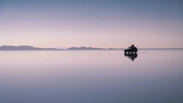 Photo of Travellers Exploring Uyuni Salt Flats at Sunrise in Bolivia, South America