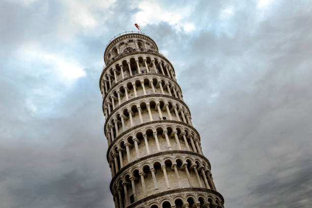 The Leaning Tower of Pisa, Italy The Leaning Tower of Pisa, Italy, famous for its tilt, with the cloudy sky. A bell tower of the nearby Pisa Cathedral, it is one of the most popular tourist attractions in Tuscany and even Italy pisa leaning tower of pisa tower famous place stock pictures, royalty-free photos & images