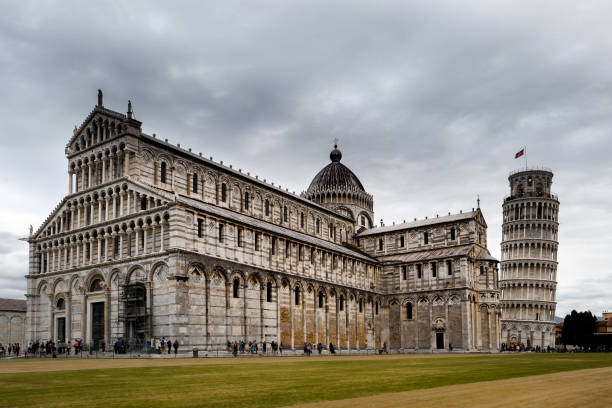 Square of Miracles with the building of the Baptistery Square of Miracles with the building of the Baptistery which represents birth, on the green grass under the blue sky in Pisa Tuscany in Italy. pisa leaning tower of pisa tower famous place stock pictures, royalty-free photos & images