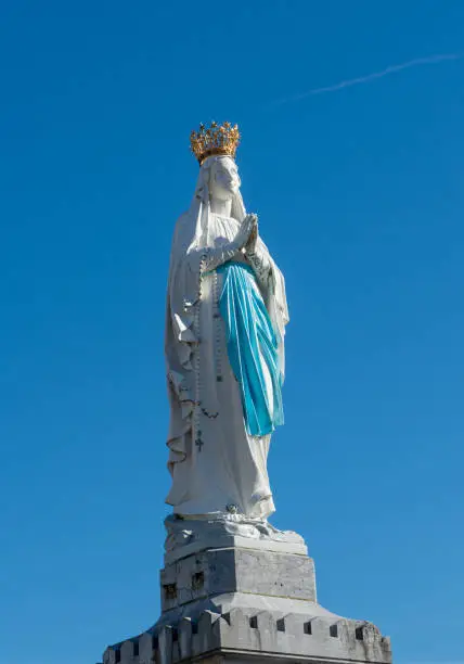 Photo of view of Virgin of Lourdes on the blue sky, France