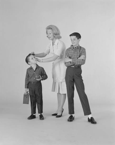 Mother dressing up two sons on white background  lunch box photos stock pictures, royalty-free photos & images