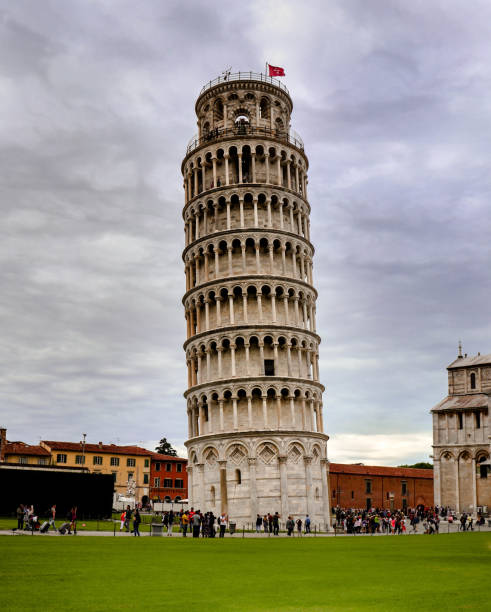 The Leaning Tower of Pisa, Italy The Leaning Tower of Pisa, Italy, famous for its tilt, with the cloudy sky. A bell tower of the nearby Pisa Cathedral, it is one of the most popular tourist attractions in Tuscany and even Italy pisa leaning tower of pisa tower famous place stock pictures, royalty-free photos & images