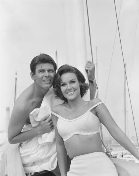 Couple leaning in boat, smiling  1964 stock pictures, royalty-free photos & images