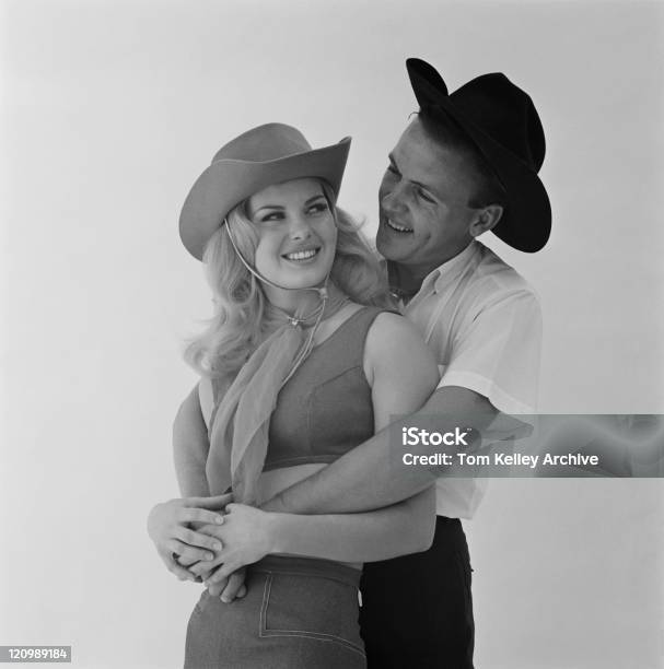 Men Embracing Women Against White Background Stock Photo - Download Image Now - Archival, 1966, Adult