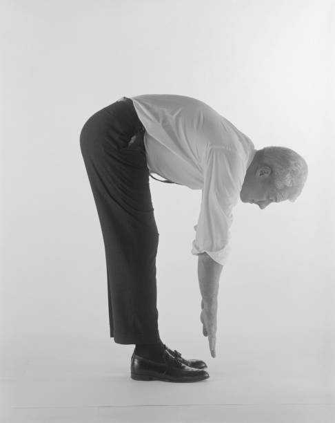 Mature man bending over against white background  brogue photos stock pictures, royalty-free photos & images