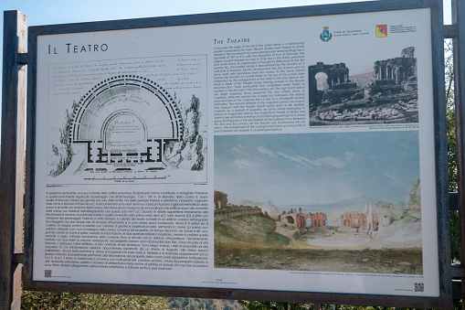 A signboard in Taormina explaining the Teatro Antico di Taormina in Sicily, Italy