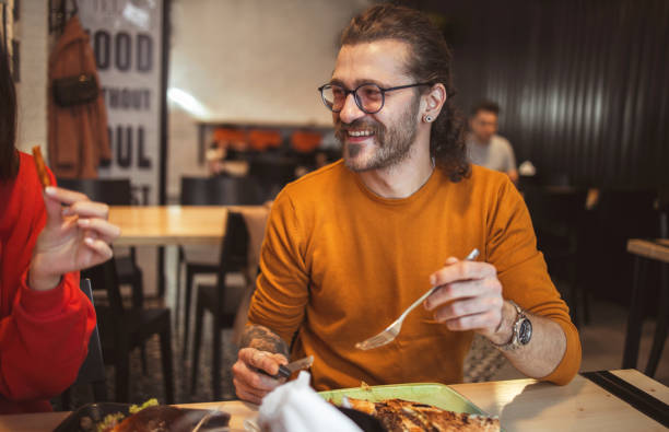 istock Young man in Fast Food Restaurant 1209894127