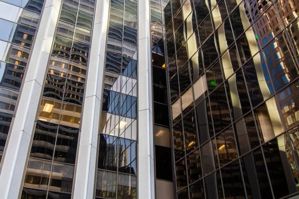 istock Glass wall of office building with reflections, perspective view 1209894206