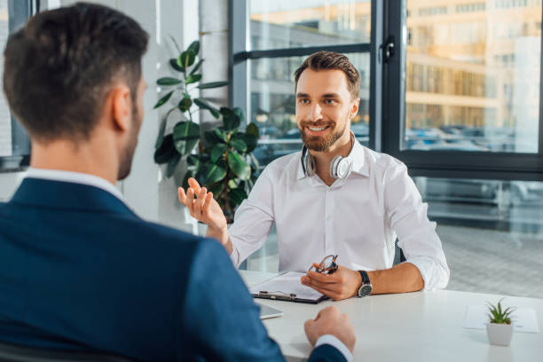 istock cheerful male translator working with businessman in modern office 1209894280