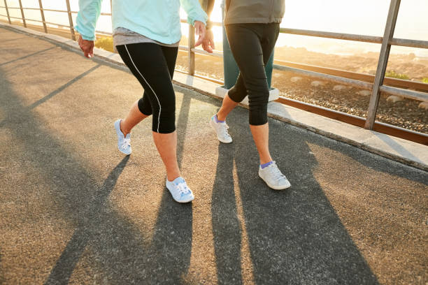 Workout with a purpose Low section shot of two female legs walking outdoors power walking photos stock pictures, royalty-free photos & images