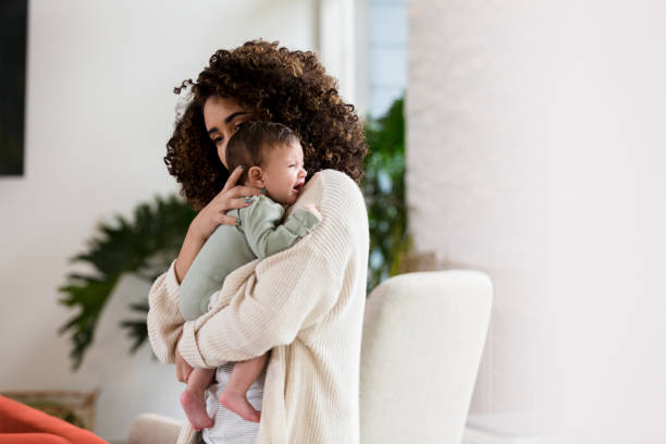 istock Young mother comforts crying baby 1209896640