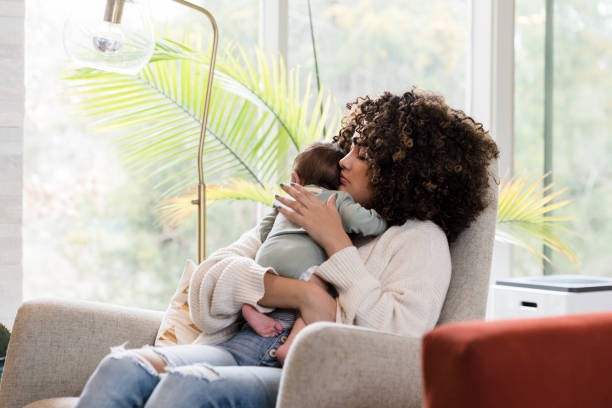 istock New mom rocks infant son 1209896669