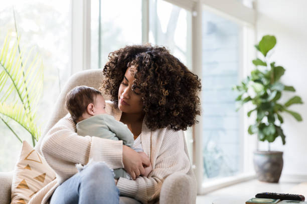 istock New mom looks at her baby lovingly 1209896676