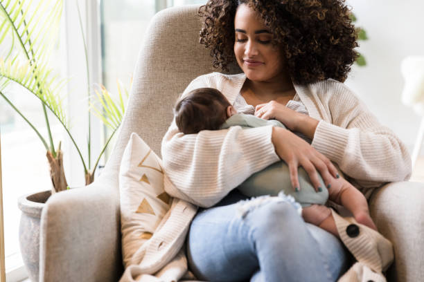 istock Happy mom breastfeeds her infant son 1209896680