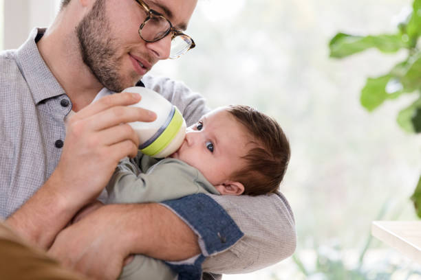 istock Dad gives infant a bottle 1209896685