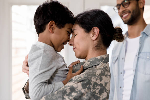 istock Before leaving, military mom touches her face to son's face 1209896813