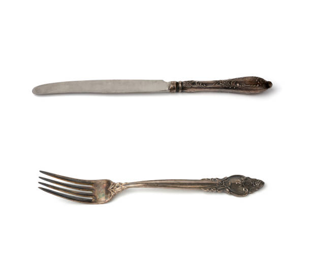 istock metal table vintage knife and fork isolated on white background 1209897510